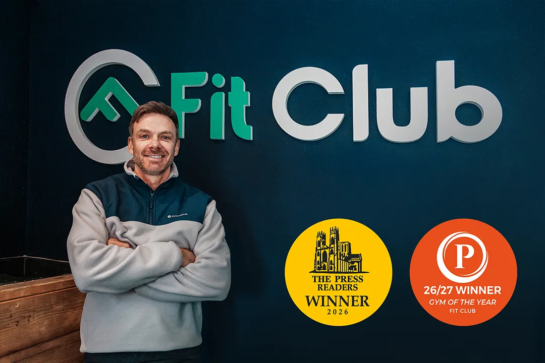 Fit Club York team member beside award winning gym signage in York