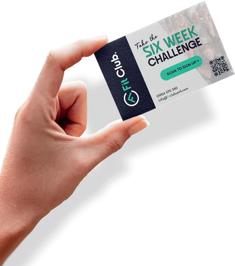 Hand holding a Fit Club York 6 Week Challenge sign-up card promoting the transformation programme with coaching and fitness support.