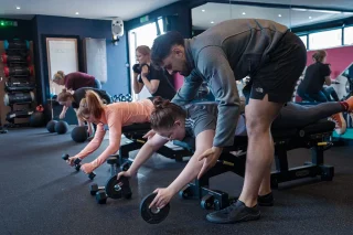Fit Club York coach helping members during a strength training session