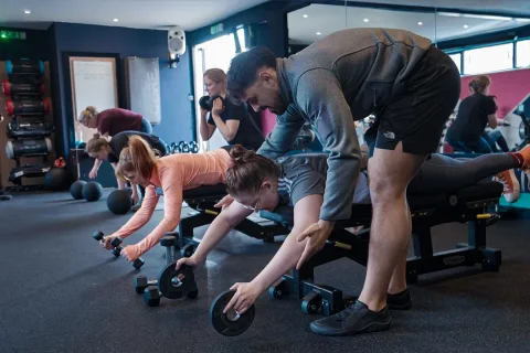 Fit Club York coach helping members during a strength training session