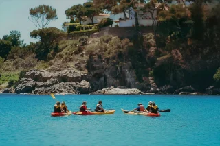 Fit Club York members kayaking together on a coastal adventure trip