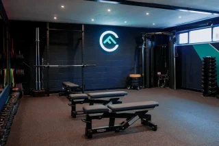 Interior of Fit Club York strength and conditioning studio with benches and weights