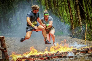 Fit Club York members completing the Total Warrior fire jump obstacle course challenge
