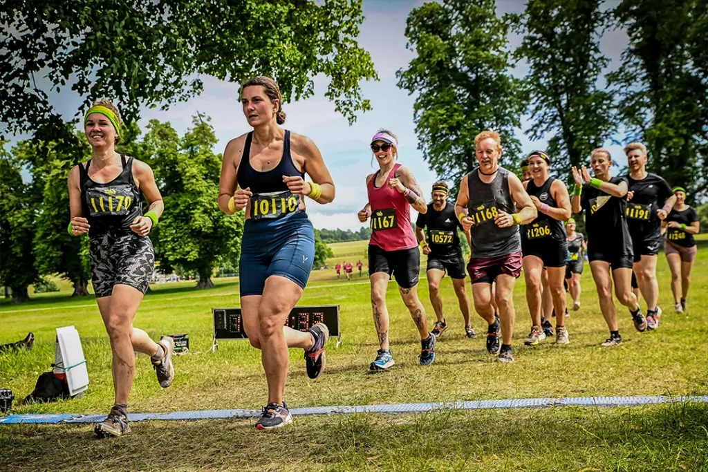 Fit Club York members running together during the Total Warrior obstacle course event