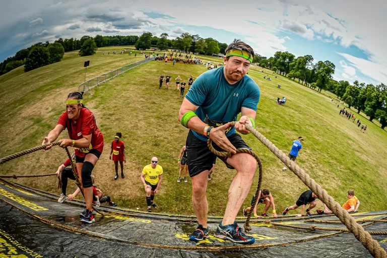 Fit Club York members climbing a rope obstacle during a Total Warrior endurance event