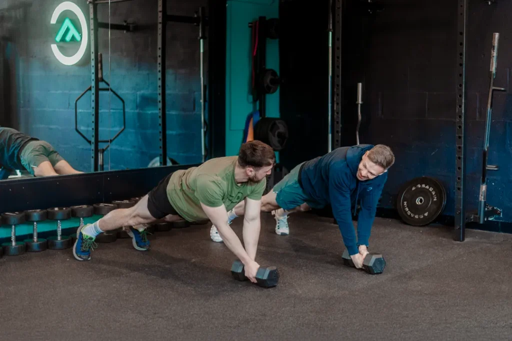 Kaine coaching a member during a strength training session at Fit Club York gym.